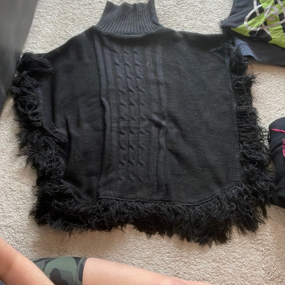 Black turtleneck poncho with fringe